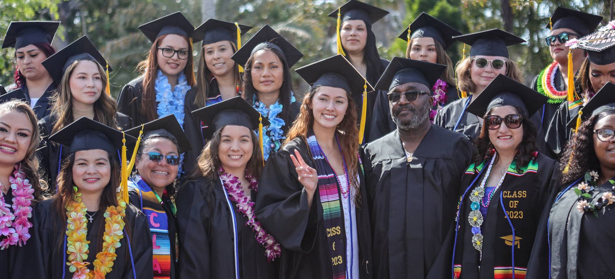 A group of students in black graduation caps and gowns at San Diego College of Continuing Education's 2023 Commencement