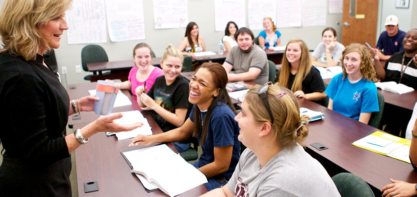 a teacher talks to students in a classroom