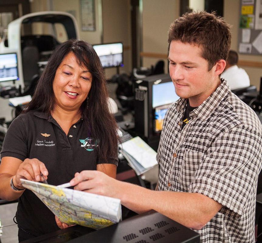 An instructor works with a student