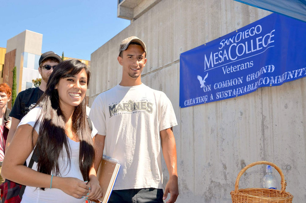 Students on steps at mesa college next to a military friendly sign