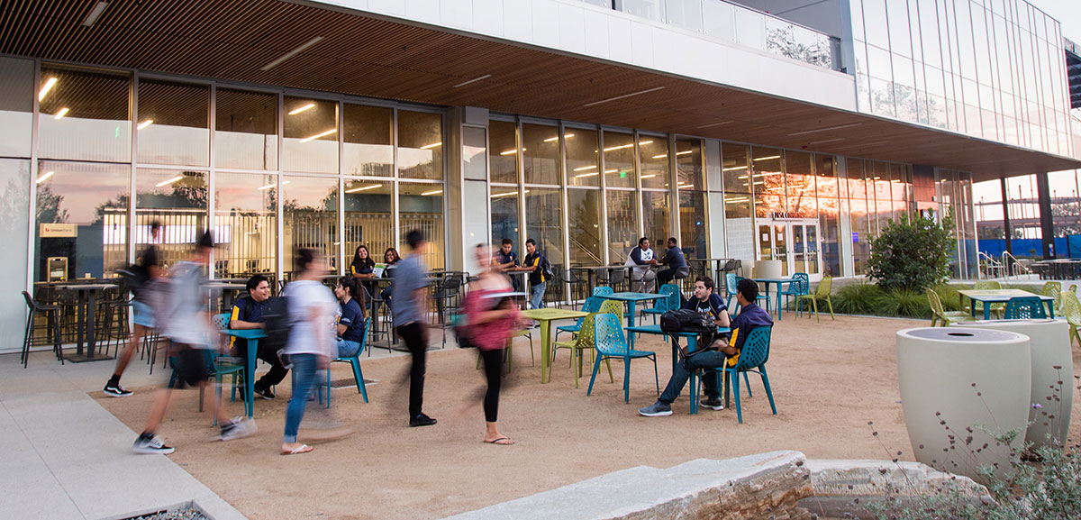 Students walk by Mesa Commons