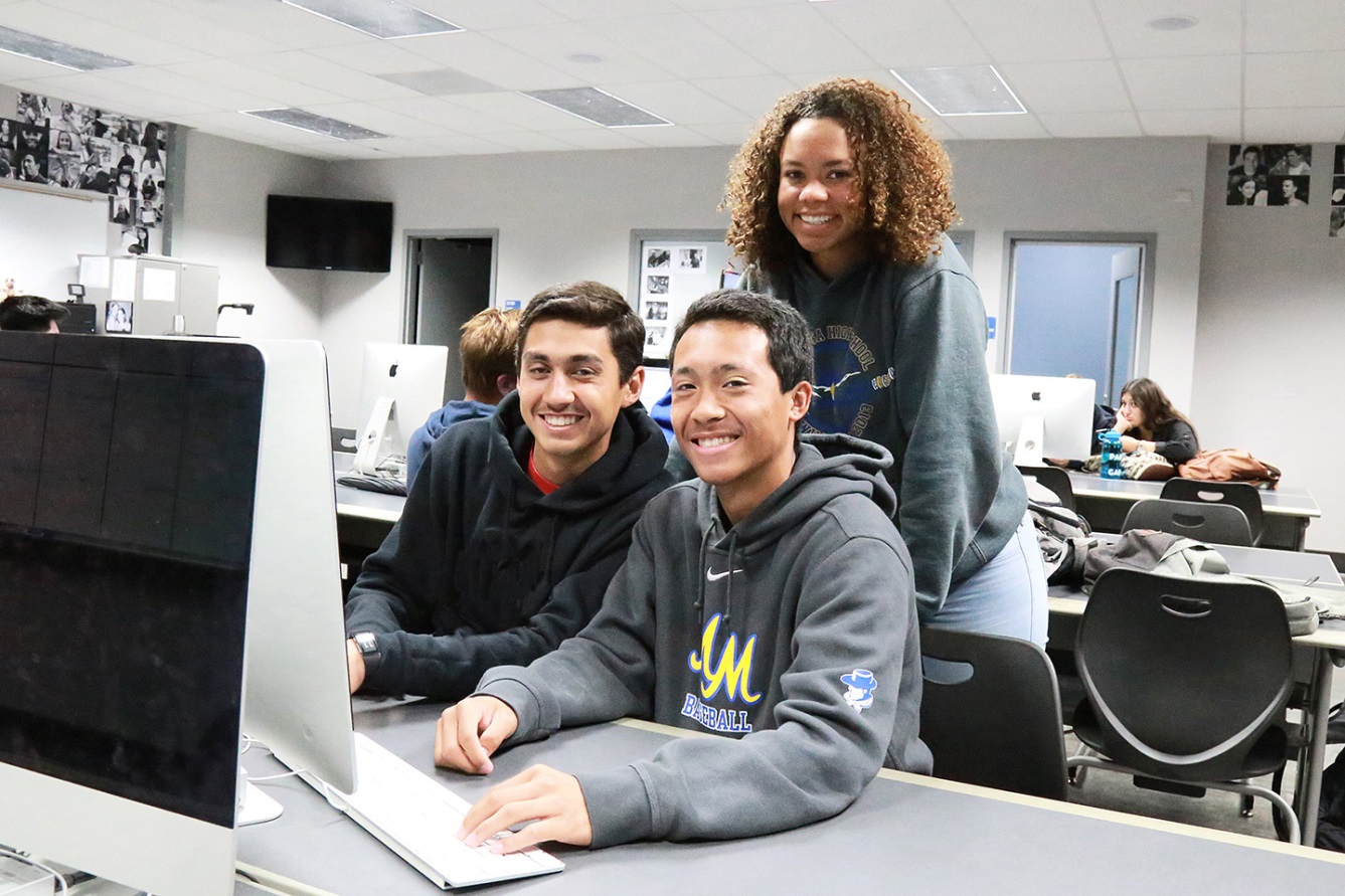 three students at a computer