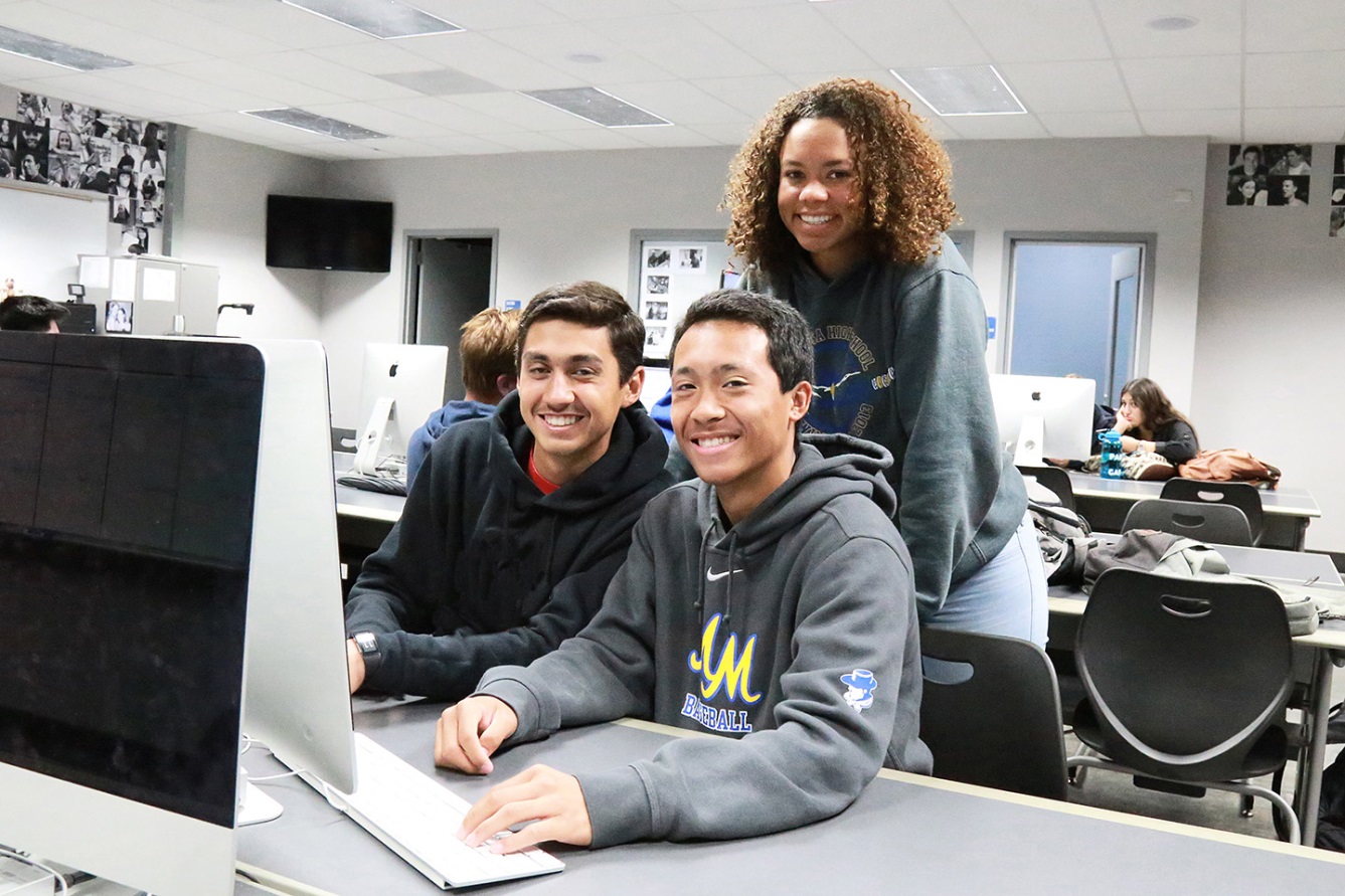 Three students at a computer