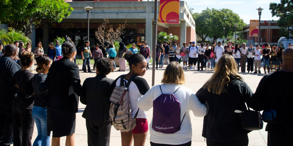 Students come together for a moment of silence at City College