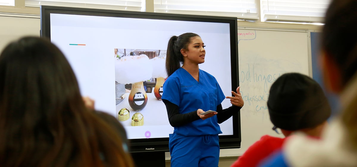A high school student gives a presentation in class