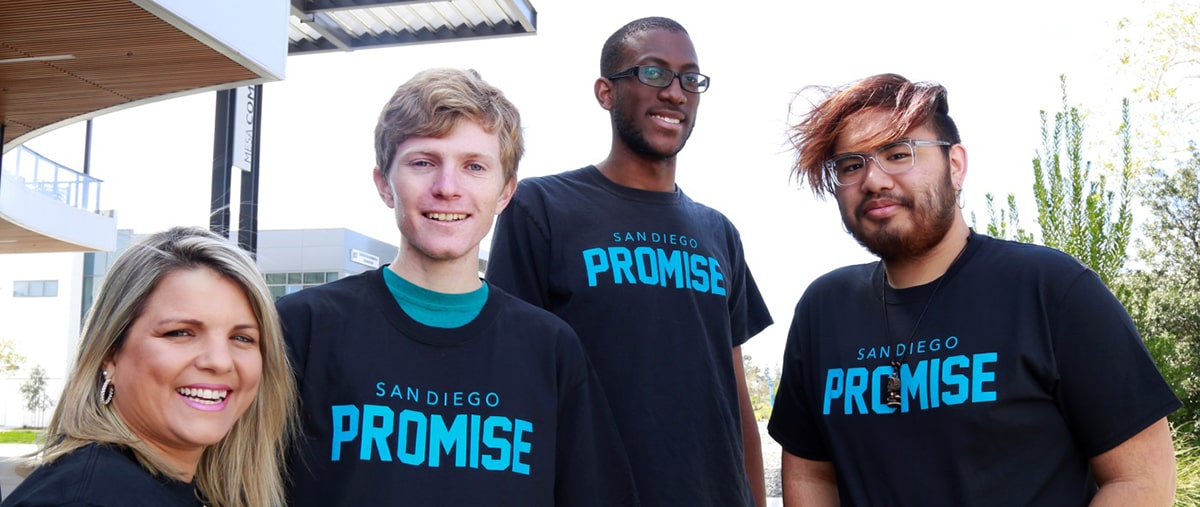 Four students wearing promise t-shirts