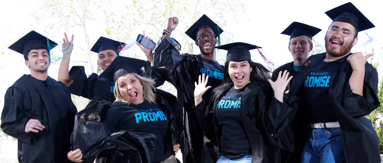 A group of students in promise tshirts and graduation caps and gowns