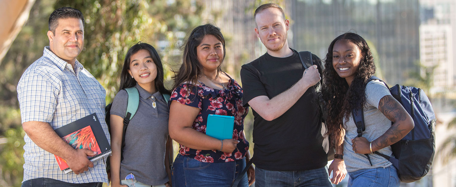 Five students wearing backpacks