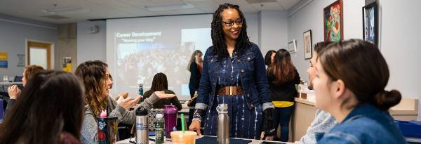 Mesa College President Ashanti Hands speaks to students at their desks in a classroom