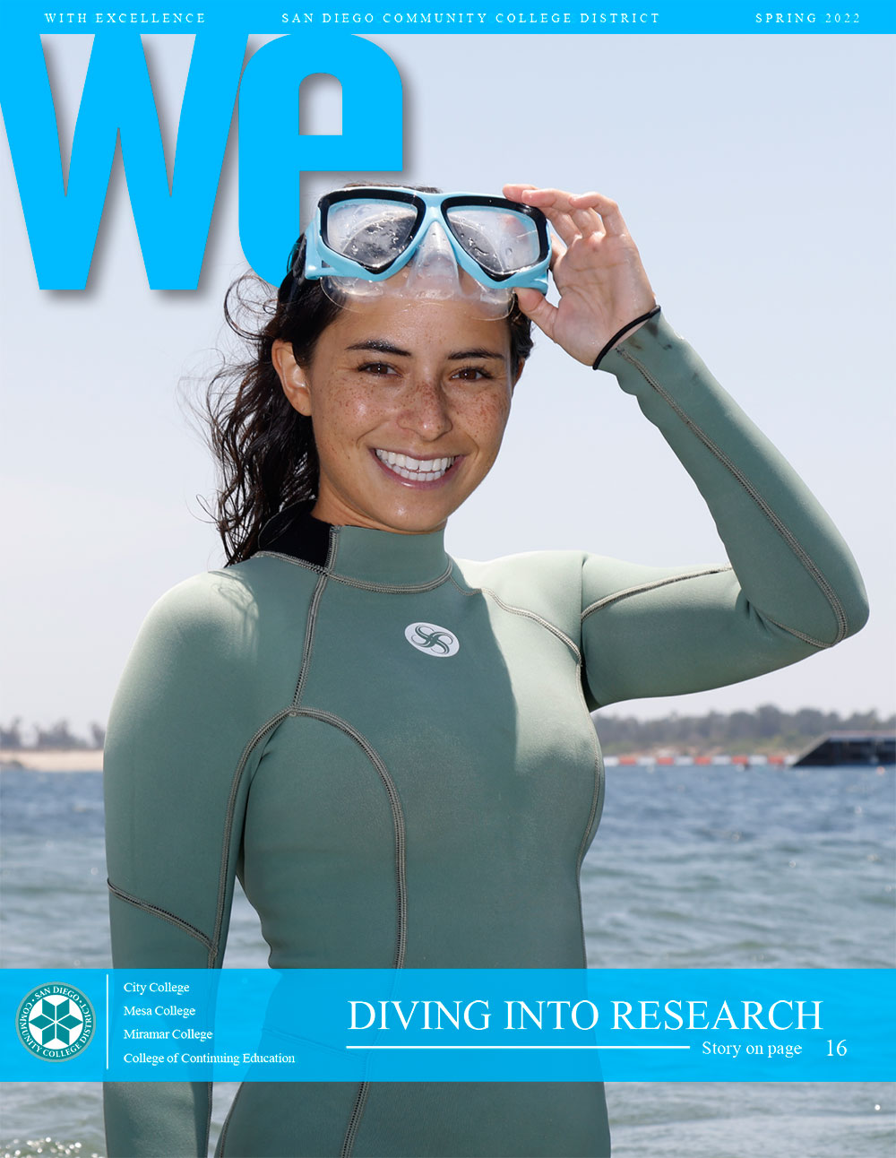 A student in a diving suit and goggles stands in front of water