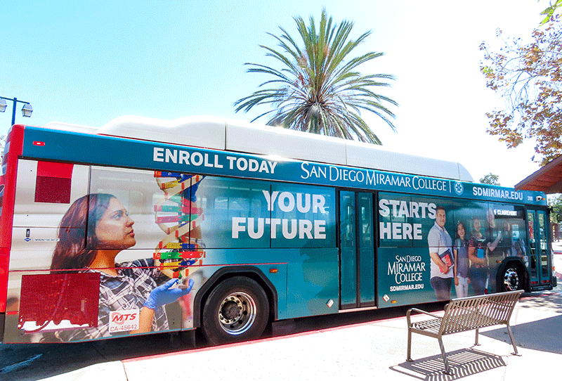 A bus wrapped with a district promotion. text reads your future starts here.