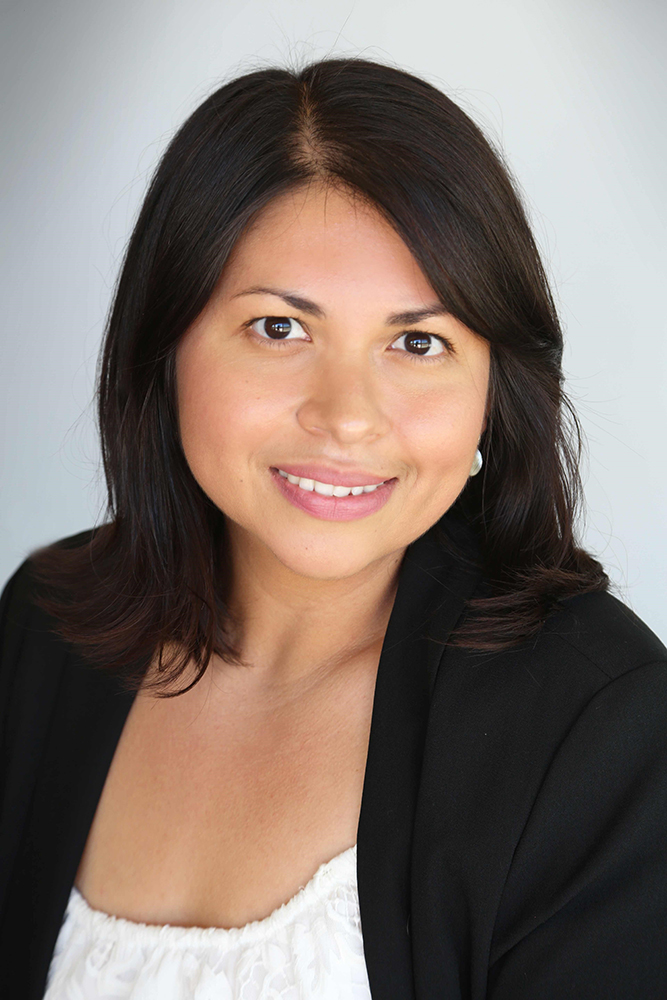 Portrait photo of Daisy Gonzales. She is wearing a black suit and a white top