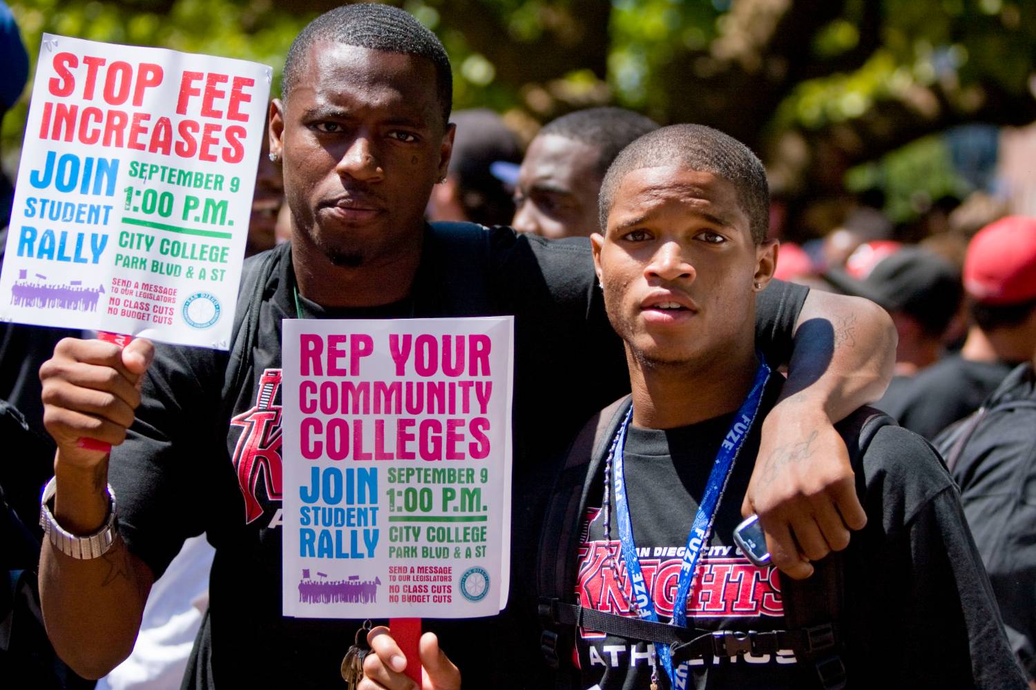 Two students at a rally in 2009 hold up signs protesting fee increases