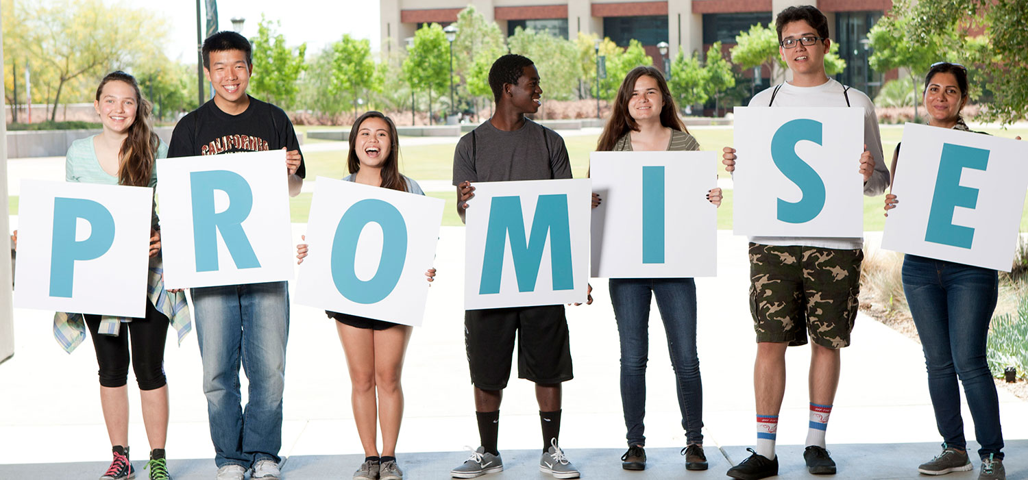 Seven students hold up letters spelling out Promise