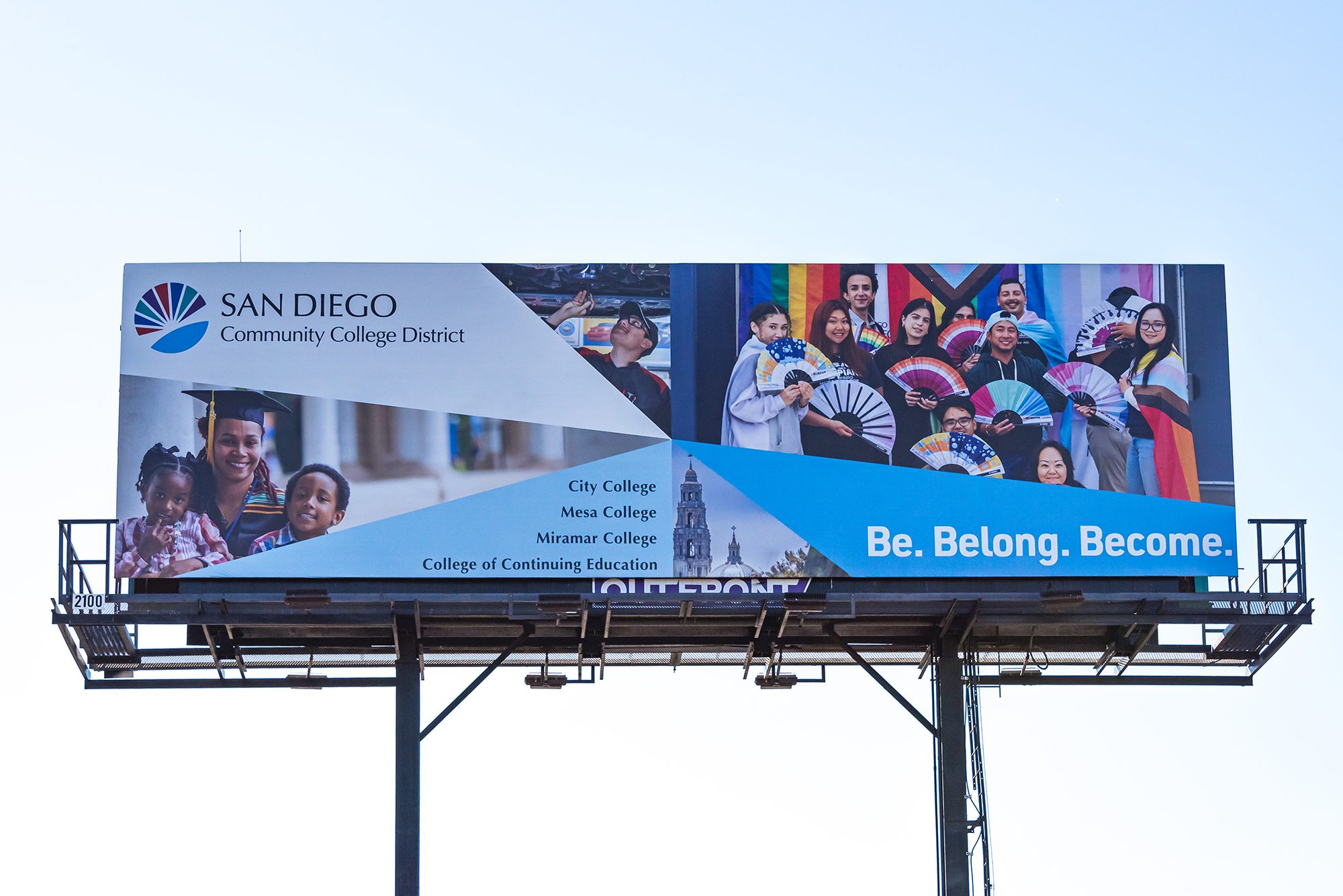 A billboard with pictures of student, district logo and tagline be belong become. 