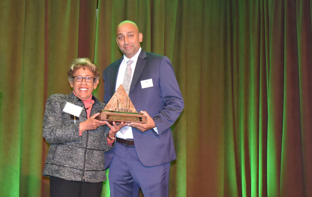 Constance M. Carroll holds a plaque