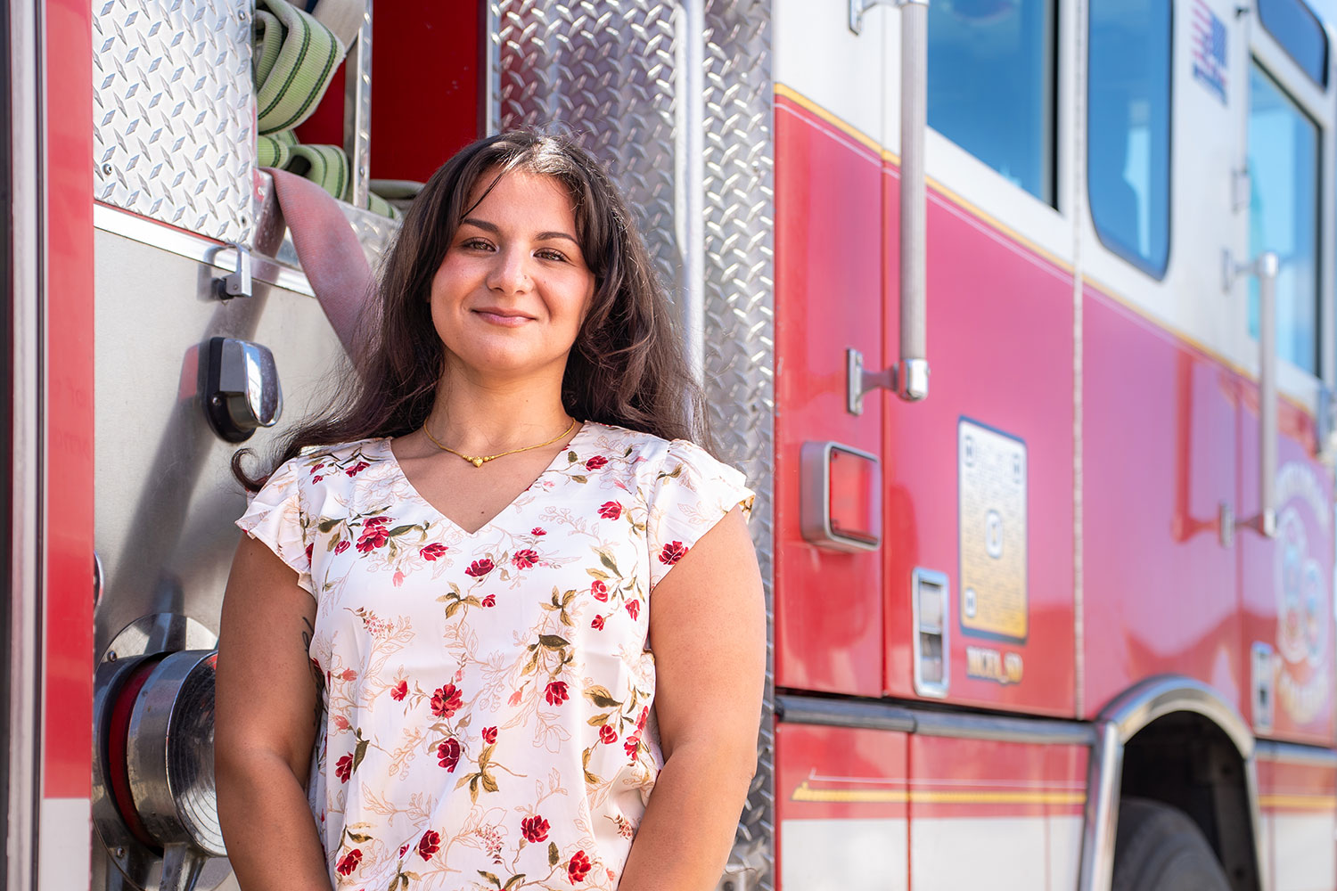 Destiny Garcia stands in front a fire engine at Miramar College.