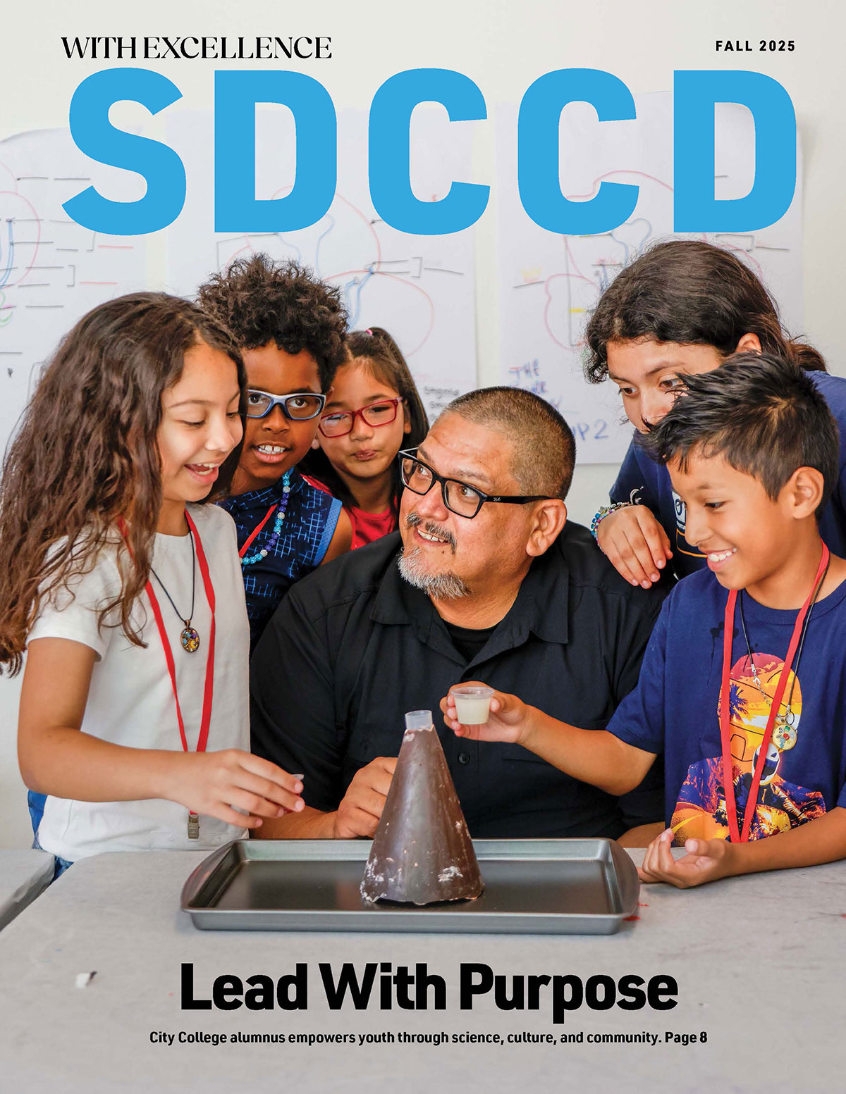 Cover of WE Magazine shows Beto Vasquez working on a volcano science project with five kids