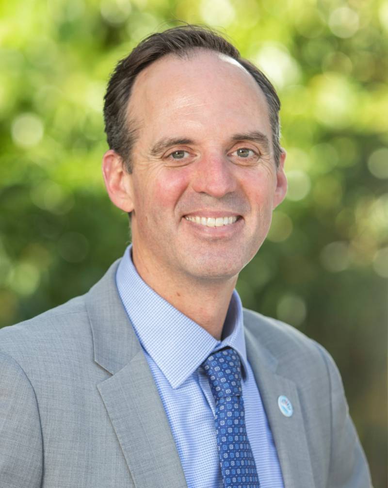 Chancellor Gregory Smith outside in a gray suit