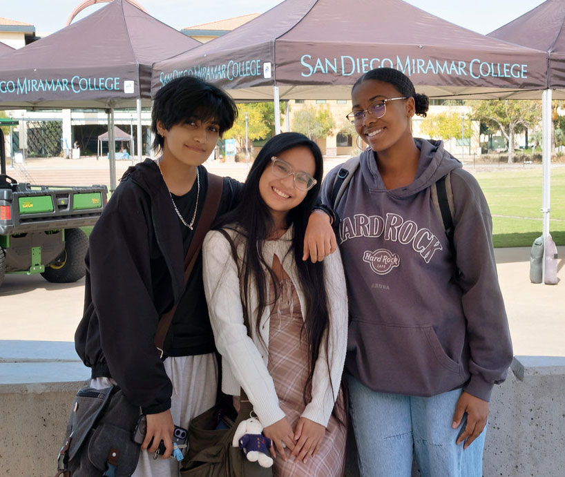 Three students hanging out on campus