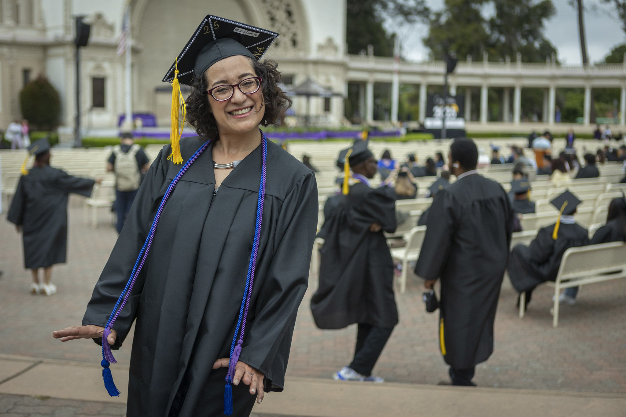 
A graduate smiling before the start of commencement.
