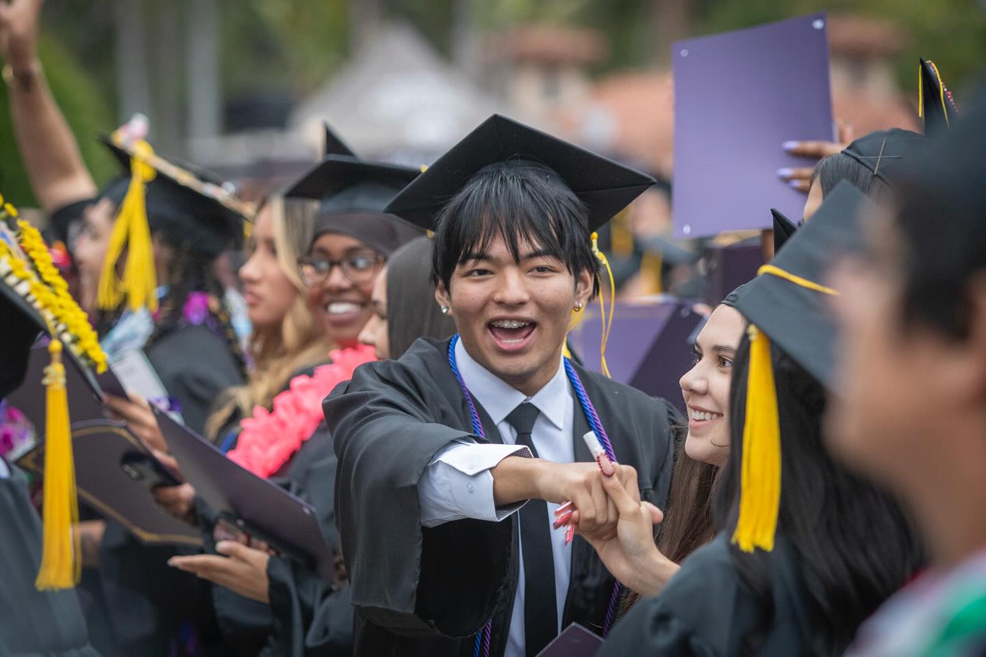 
Graduates cheering in the crowd.
