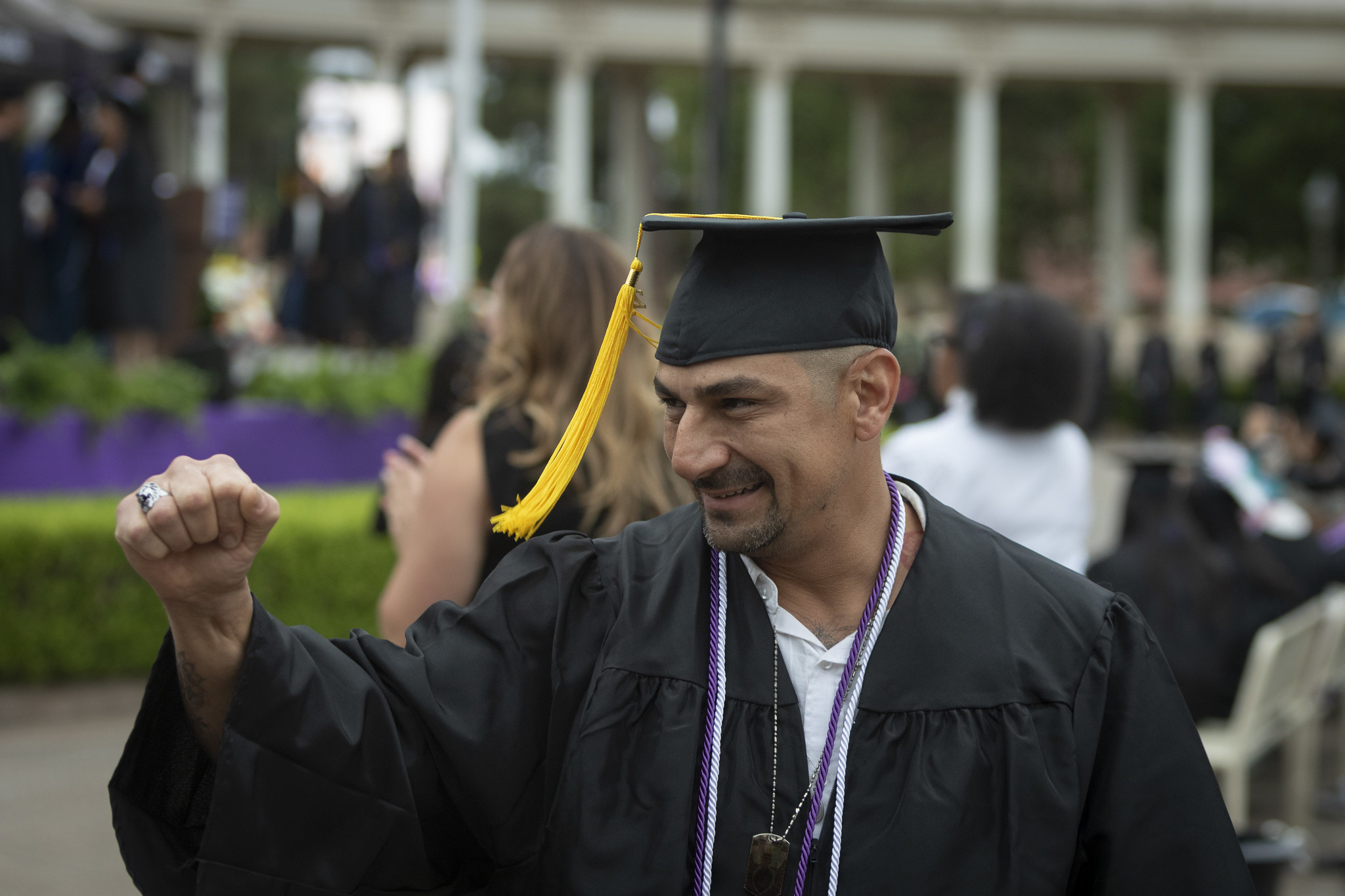 
A graduate giving a fist bump.
