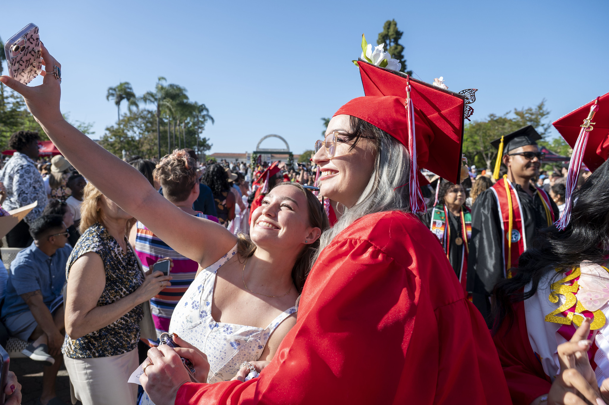 
A graduate takes a selfie with a family member.

