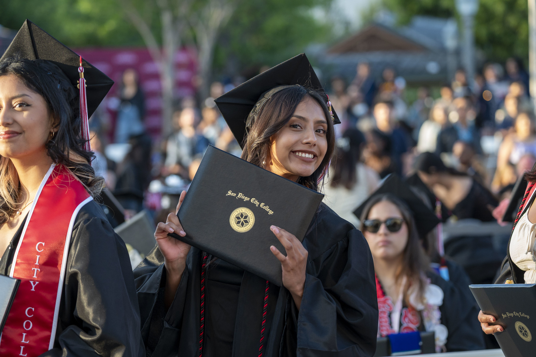 
A graduate holds up her degree.

