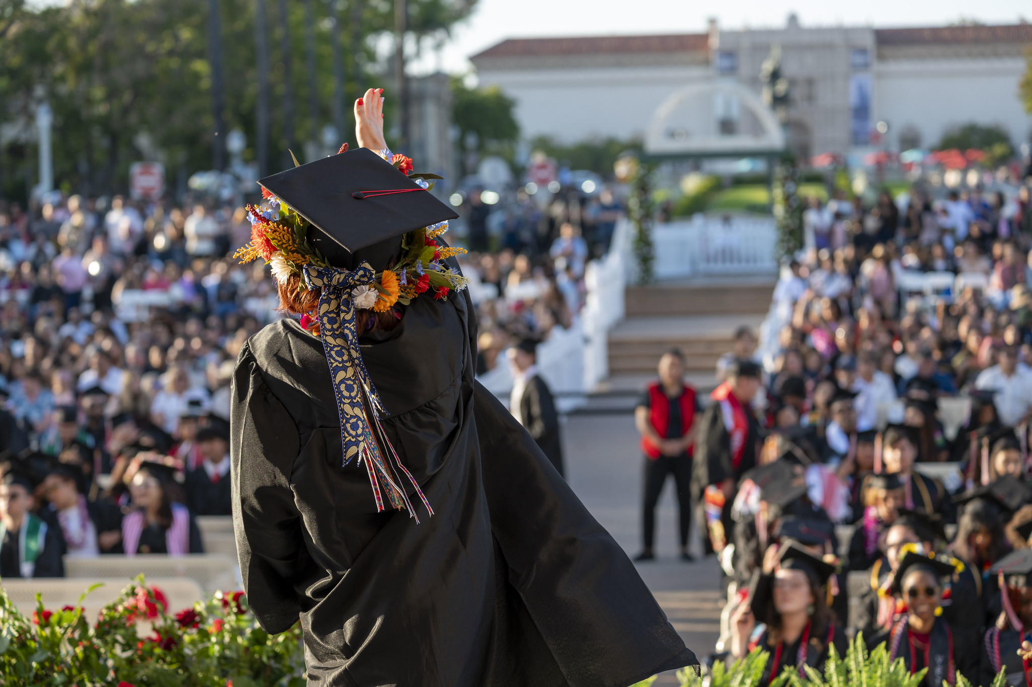 
A graduate holds up her degree.
