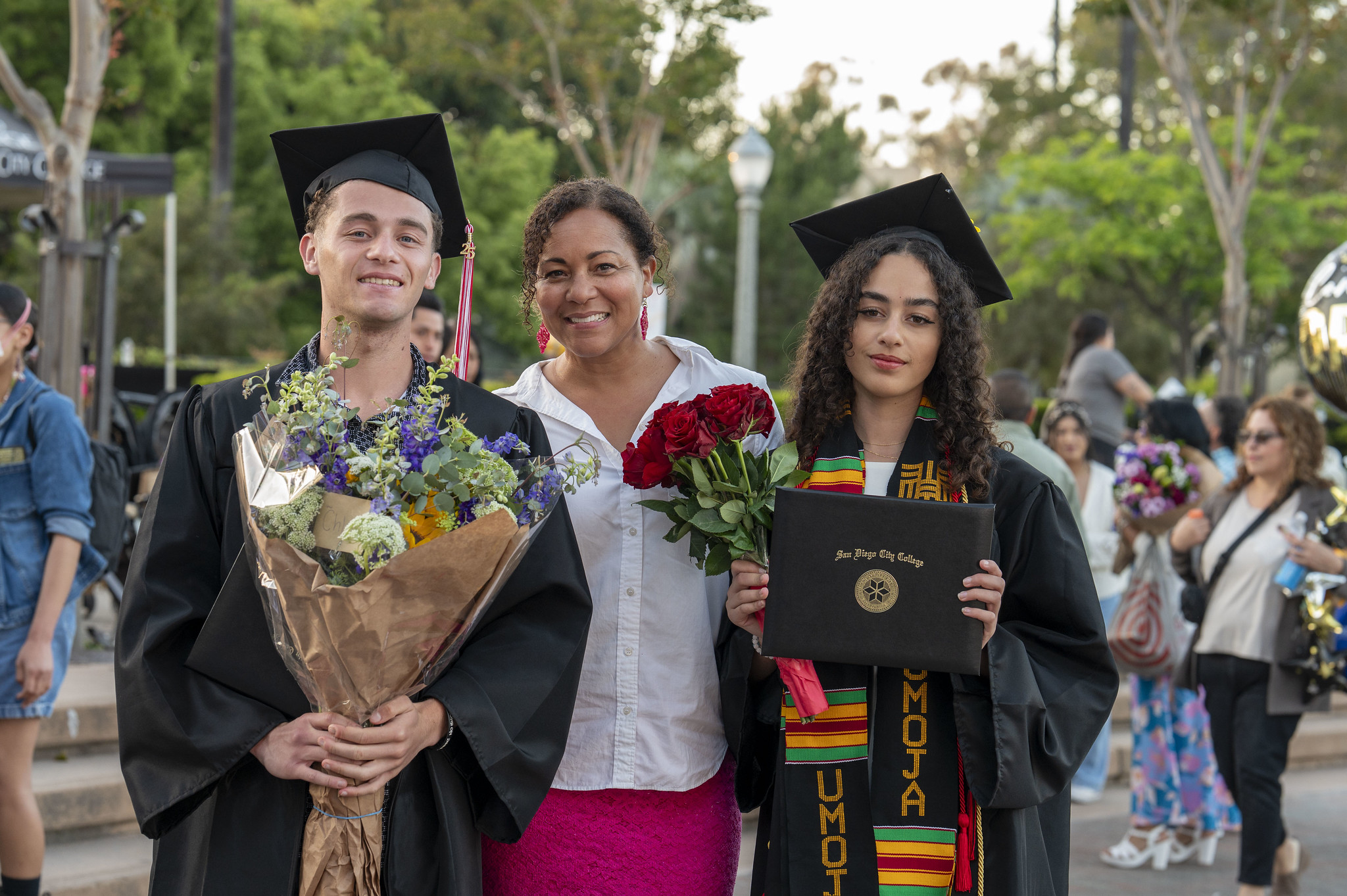 
Two graduates with a family member.
