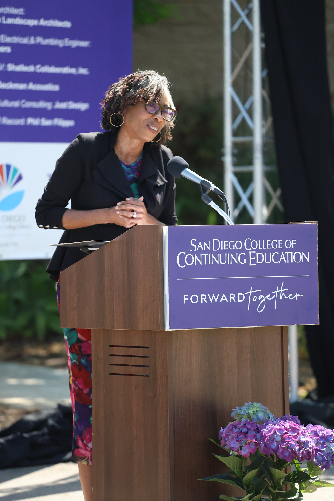 
A woman speaking at a podium.
