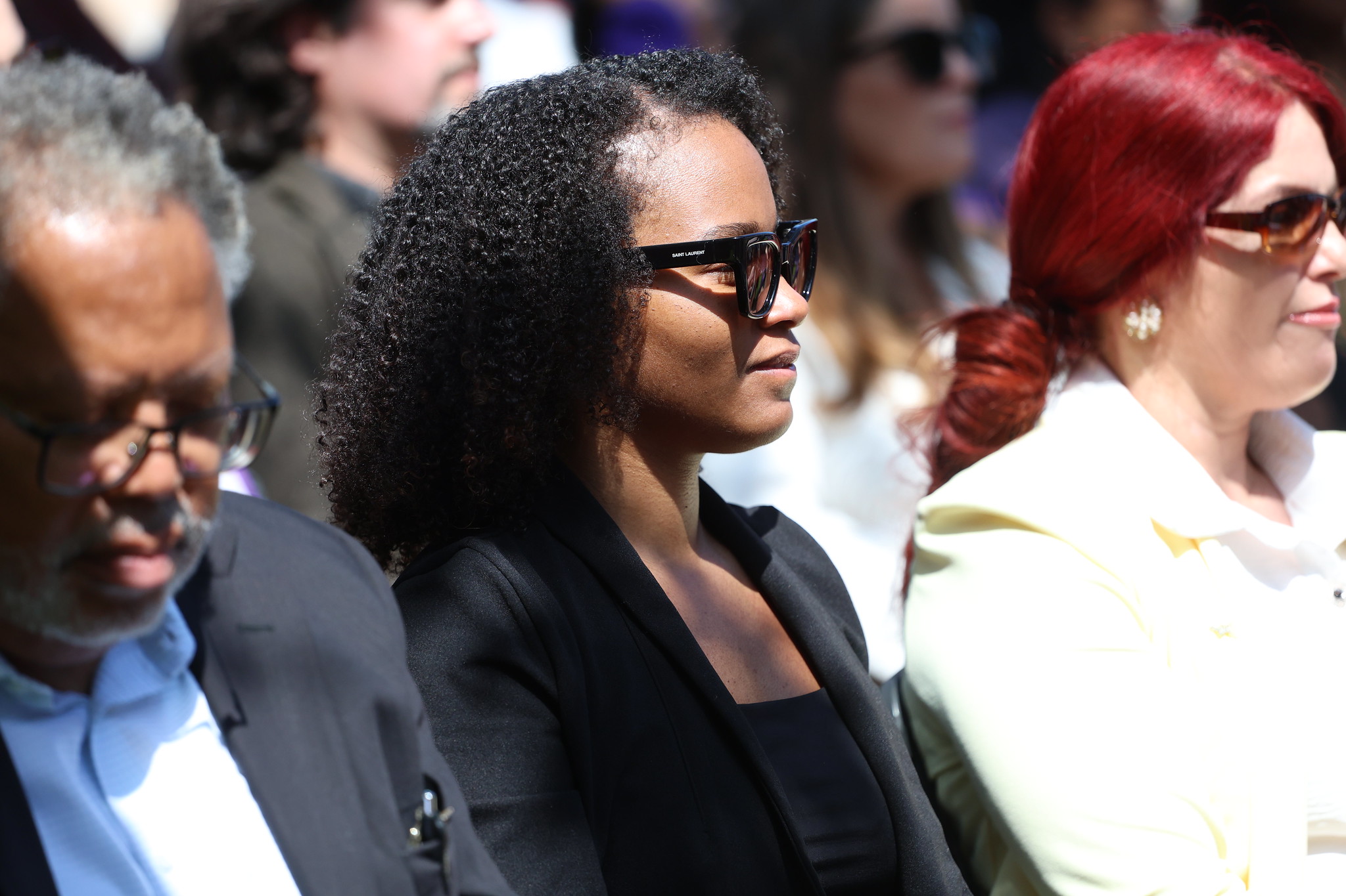 
A woman in the audience smiling.
