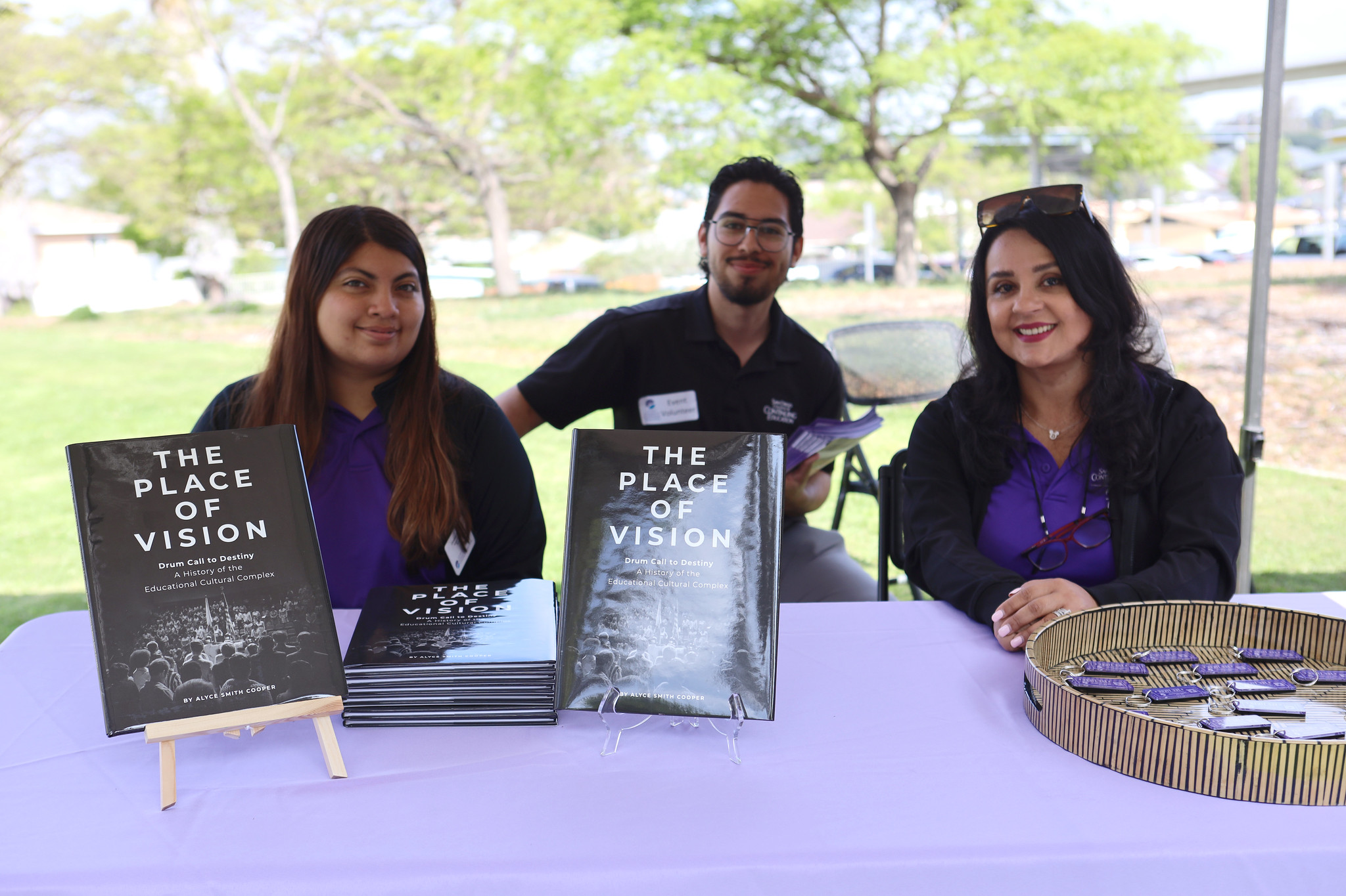 
Three people sitting at a table where the day's program is displayed.
