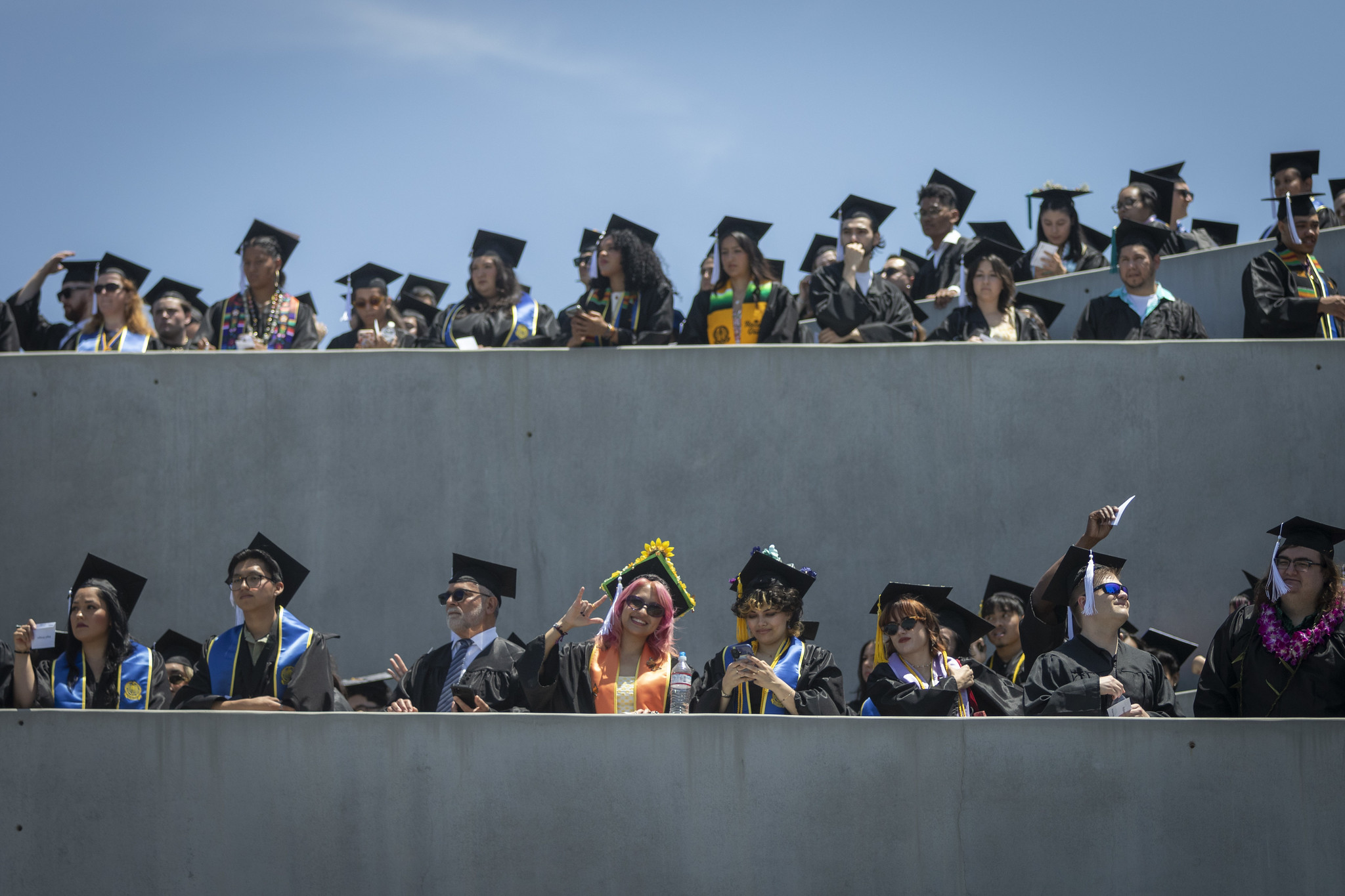 
Graduates lined up on two tiers of the ramp that lead to the field of the stadium.
