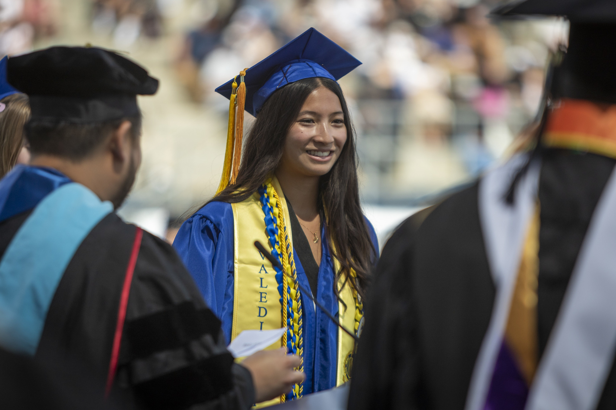
Mesa College valedictorian on stage getting her degree.
