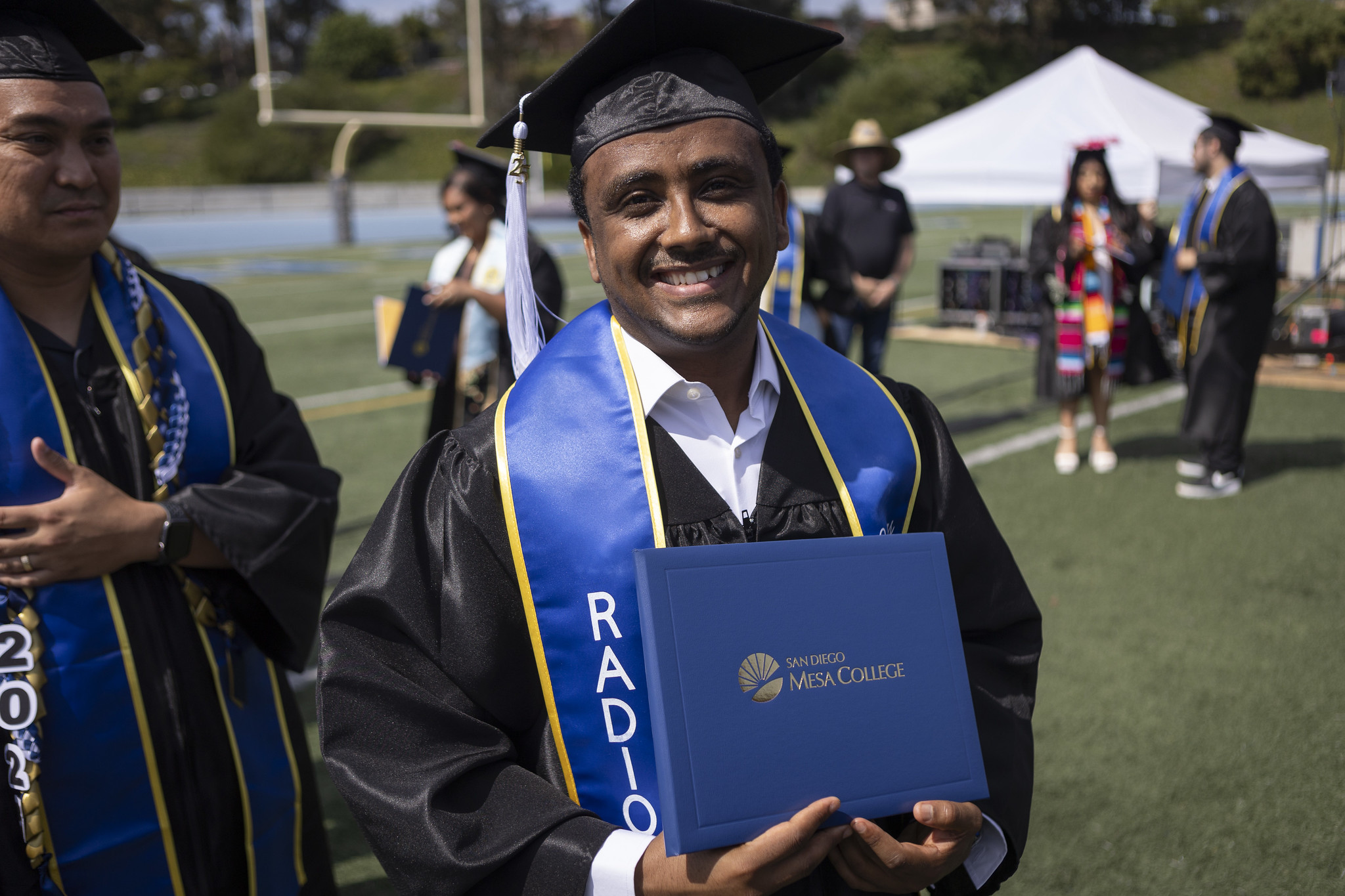 
A graduate holds up his diploma.
