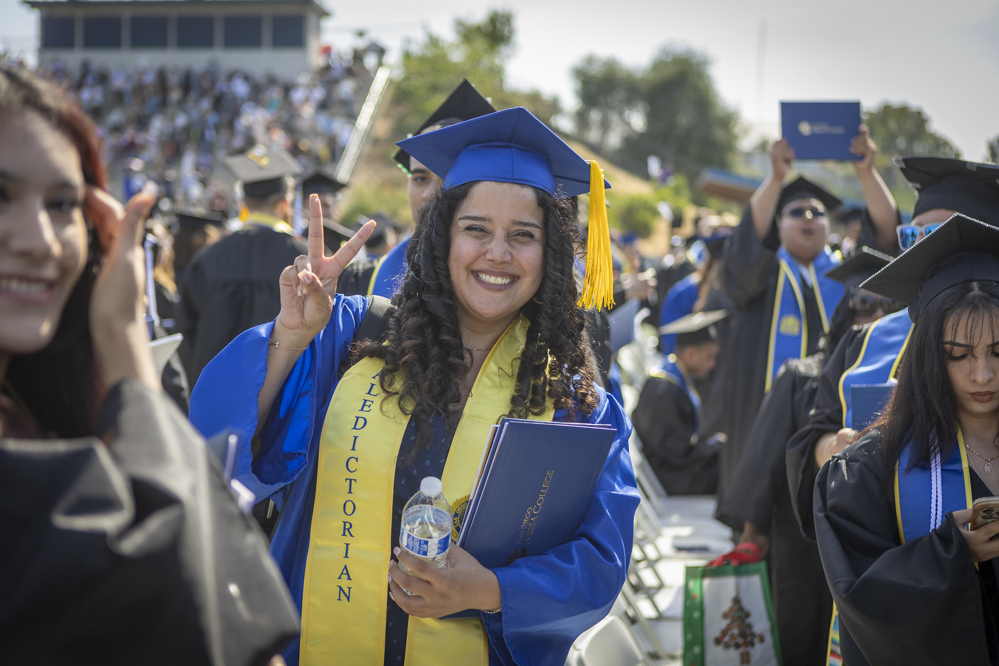
Mesa College valedictorian gives a peace sign at commencement.
