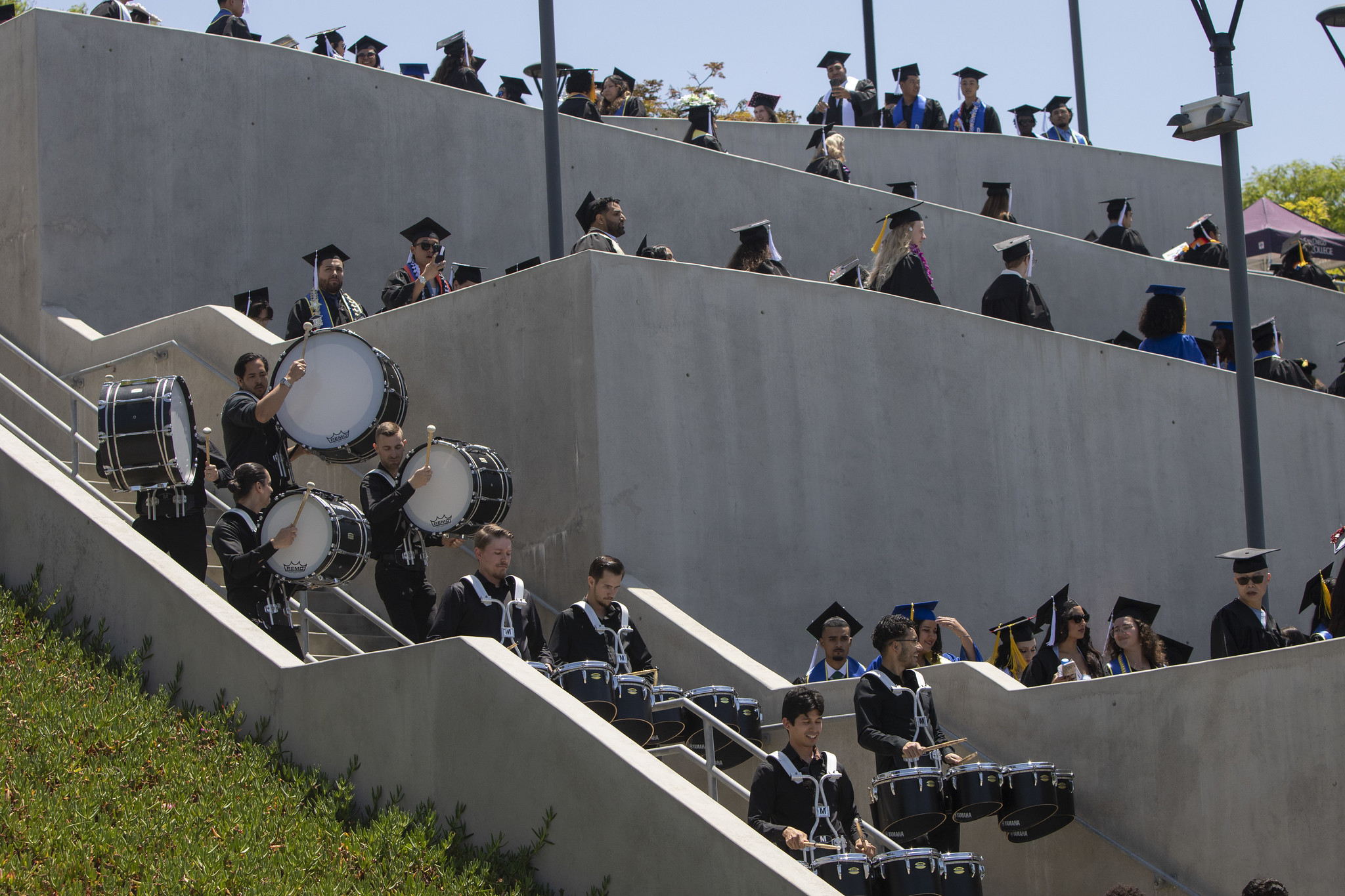 
The drum team marches down the ramp on to the field and performs at the commencement ceremony.
