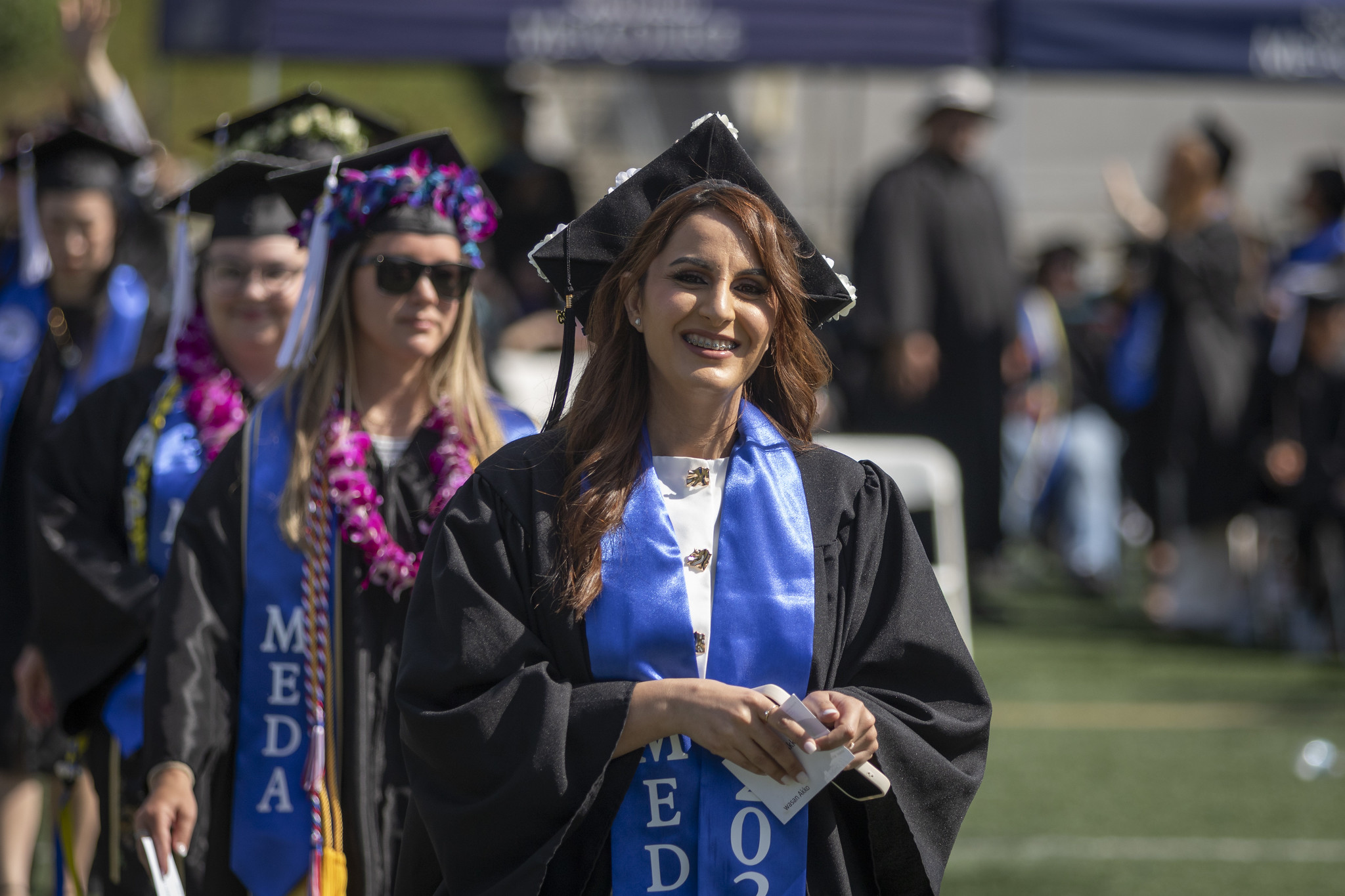 
A line of students walking into commencement.
