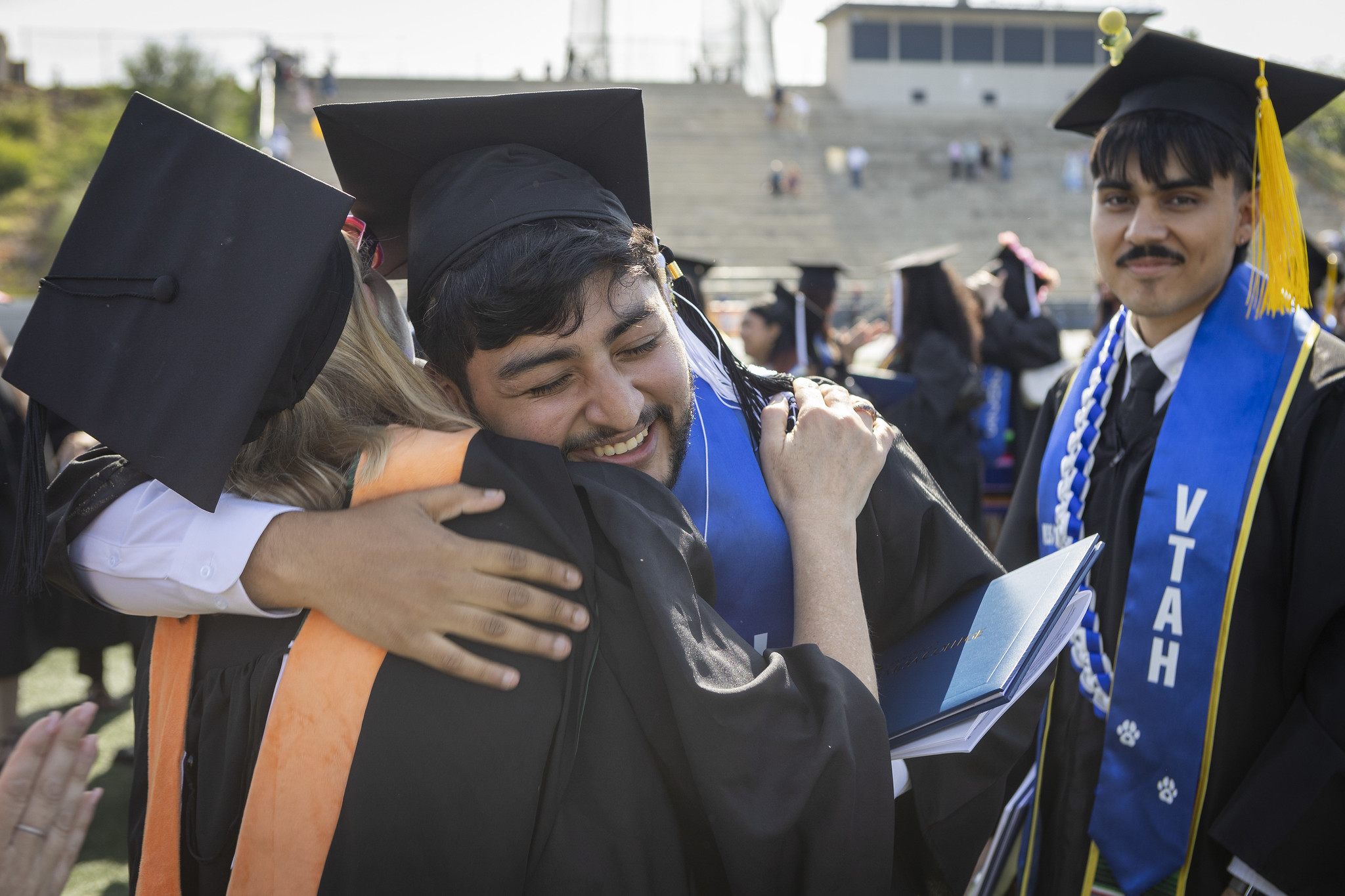 
Two graduates hug.
