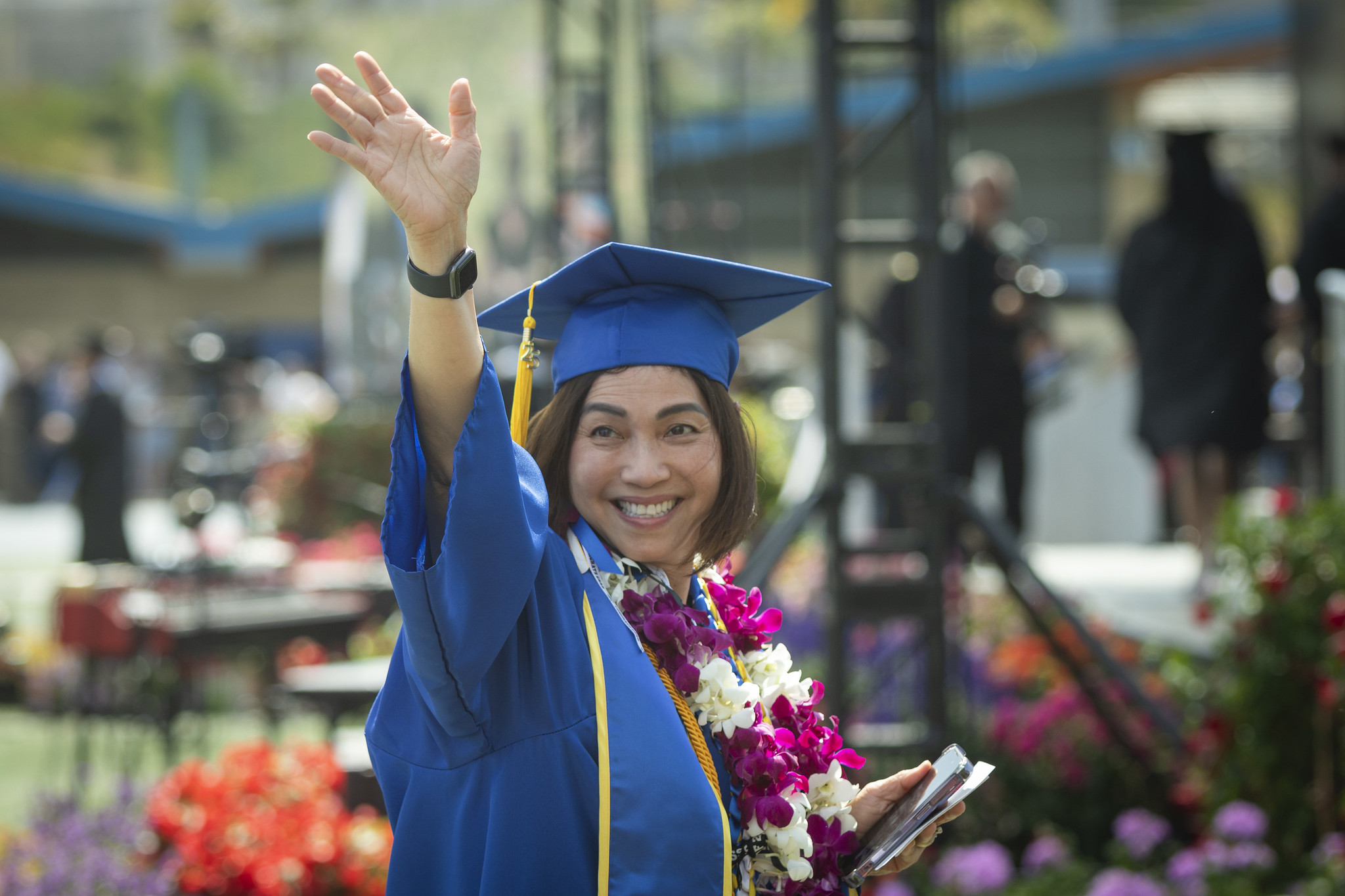 
A graduate waves to the audience.
