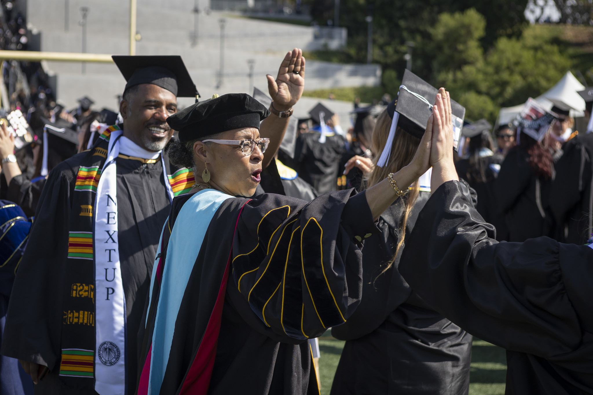 
Mesa College President Ashanti Hands gives a graduate a high-five.
