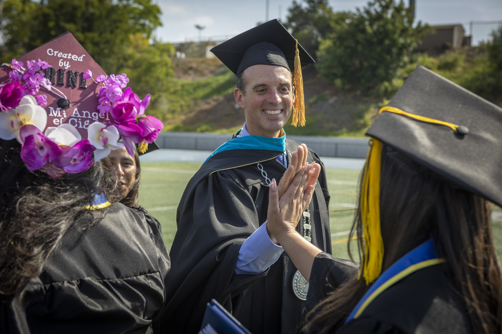 
Chancellor Gregory Smith gives a high-five to a graduate.
