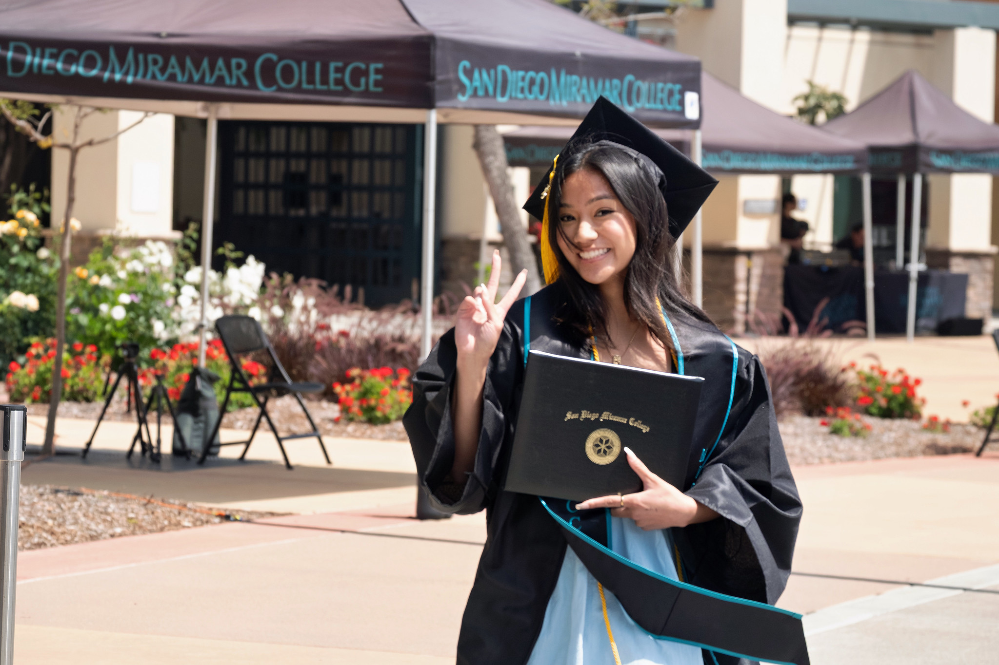 
A graduate holds up her degree.

