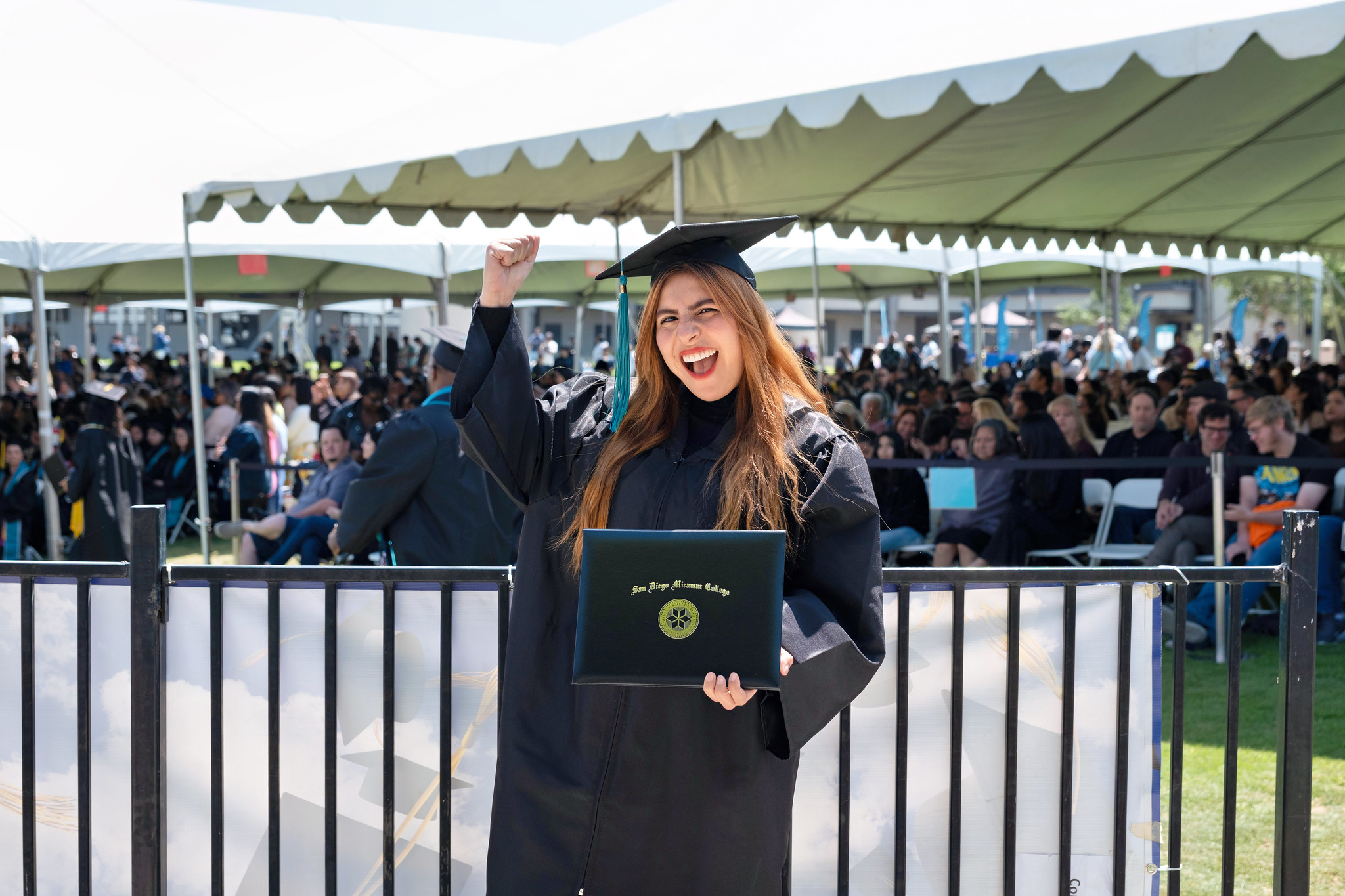 
A graduate holds up her degree.
