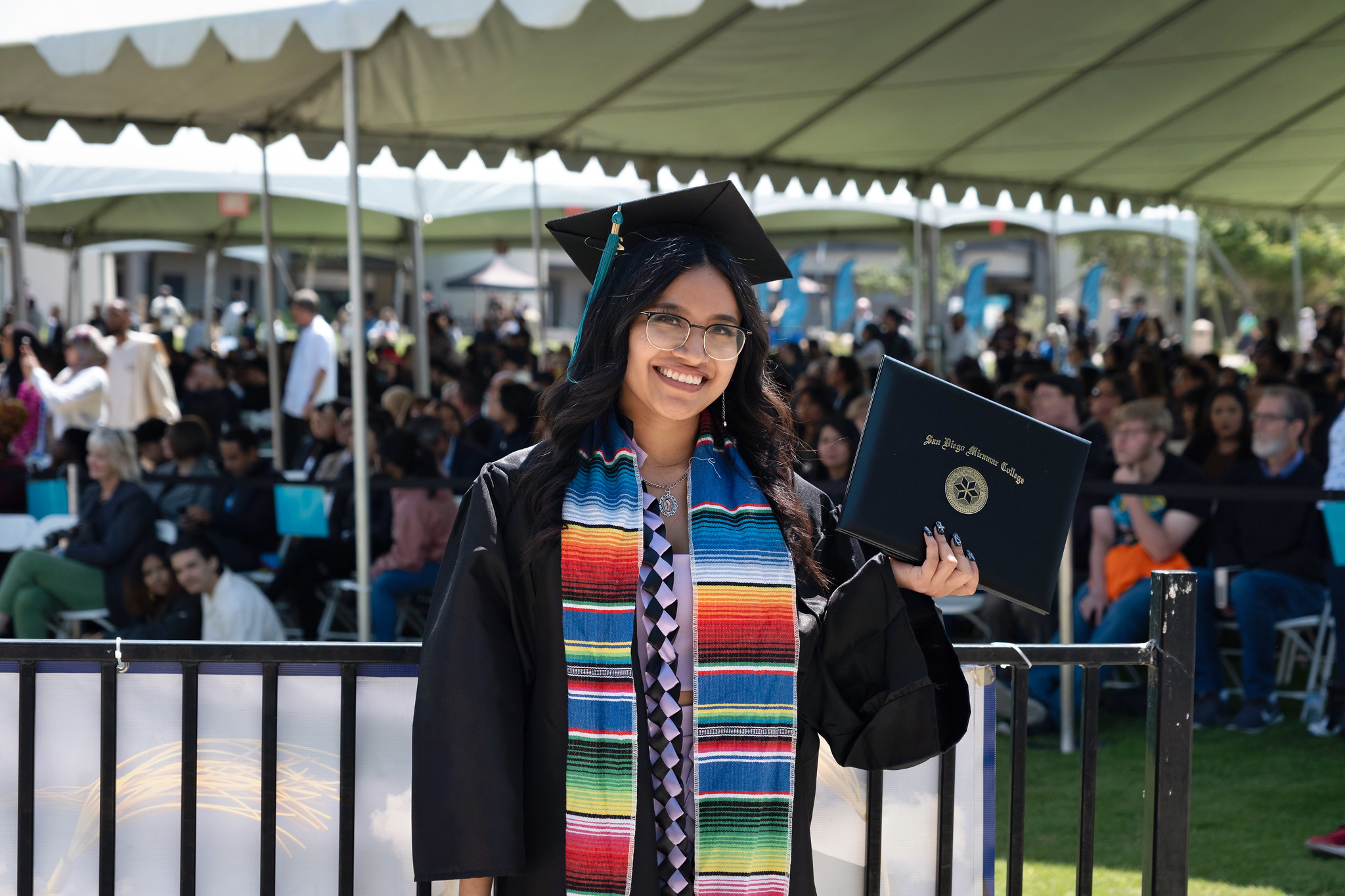 
A graduate holds up her degree.
