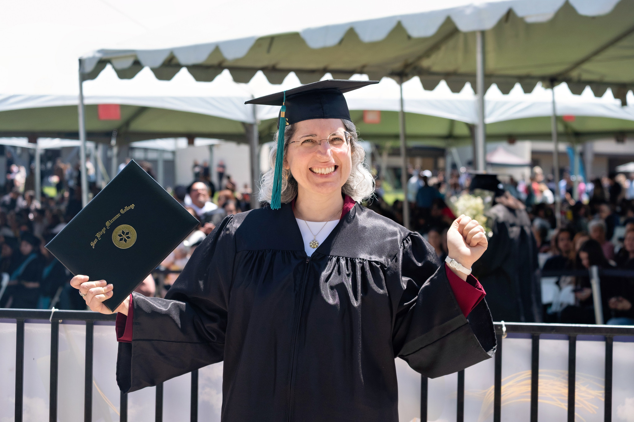 
A graduate holds up her degree.

