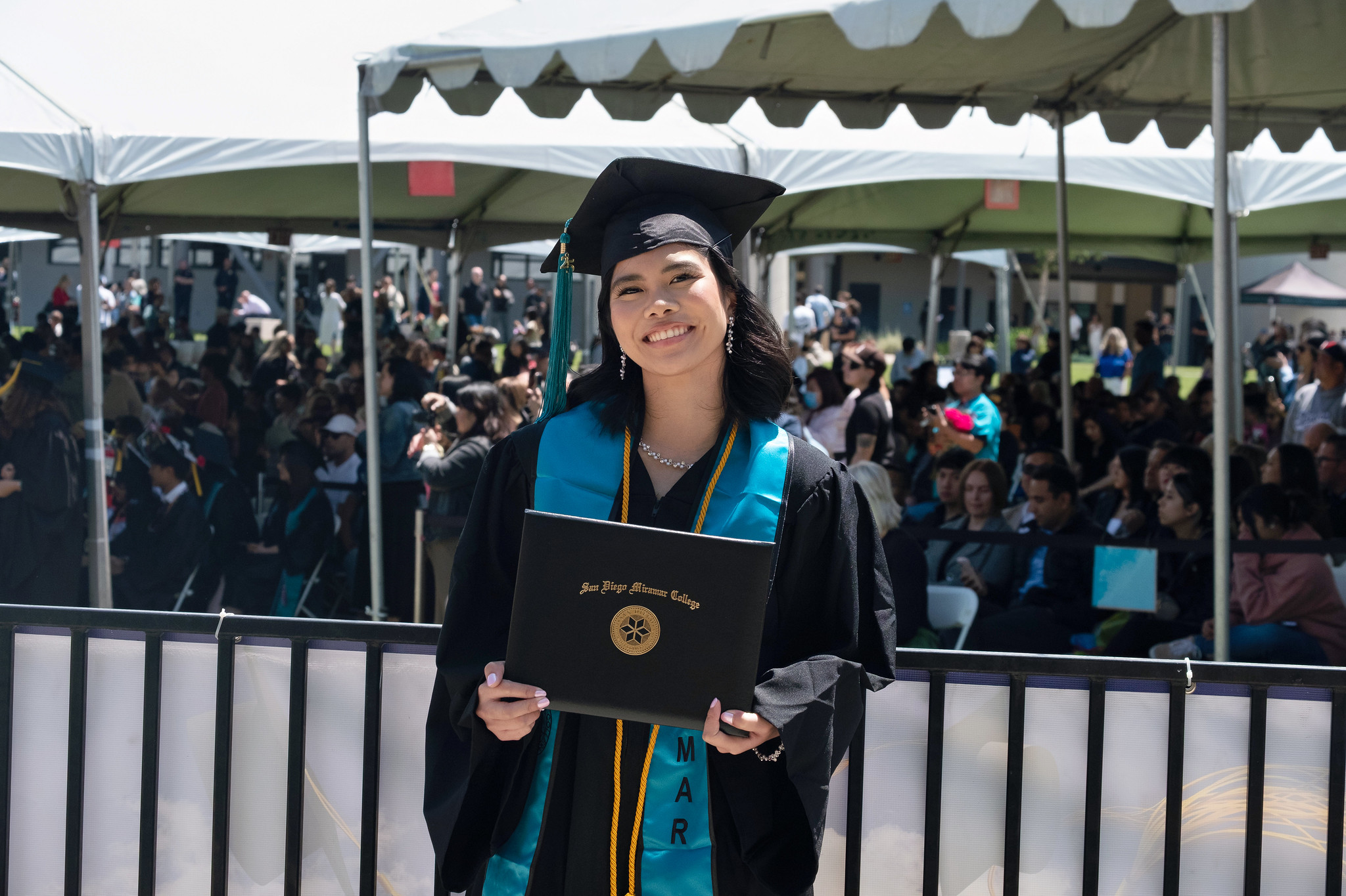 
A graduate holds up her degree.
