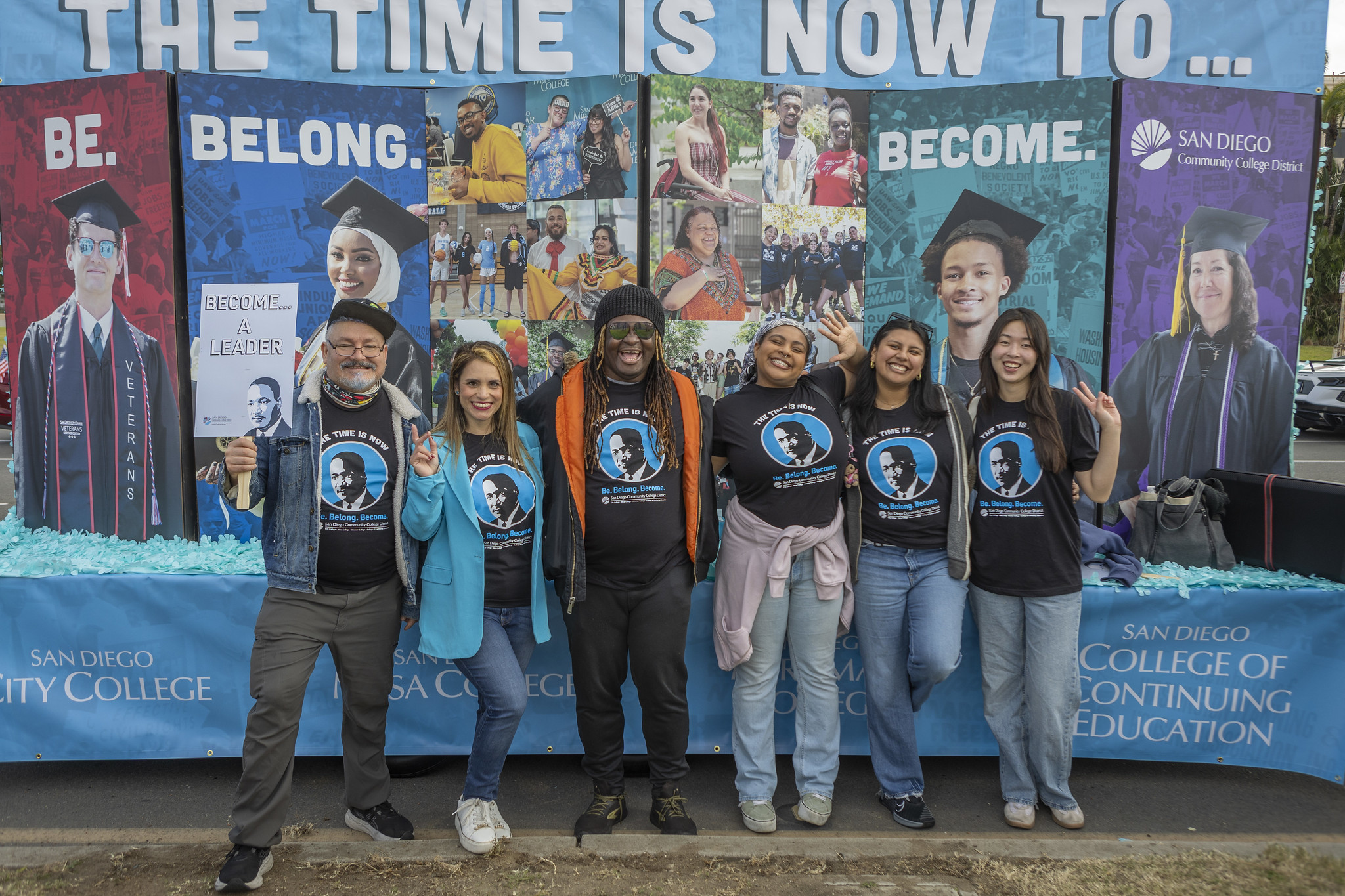 Six student leaders in front of a parade float.